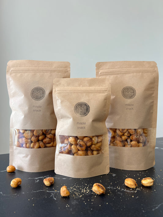 three maple snack bags of maple kernels on a grey marble counter