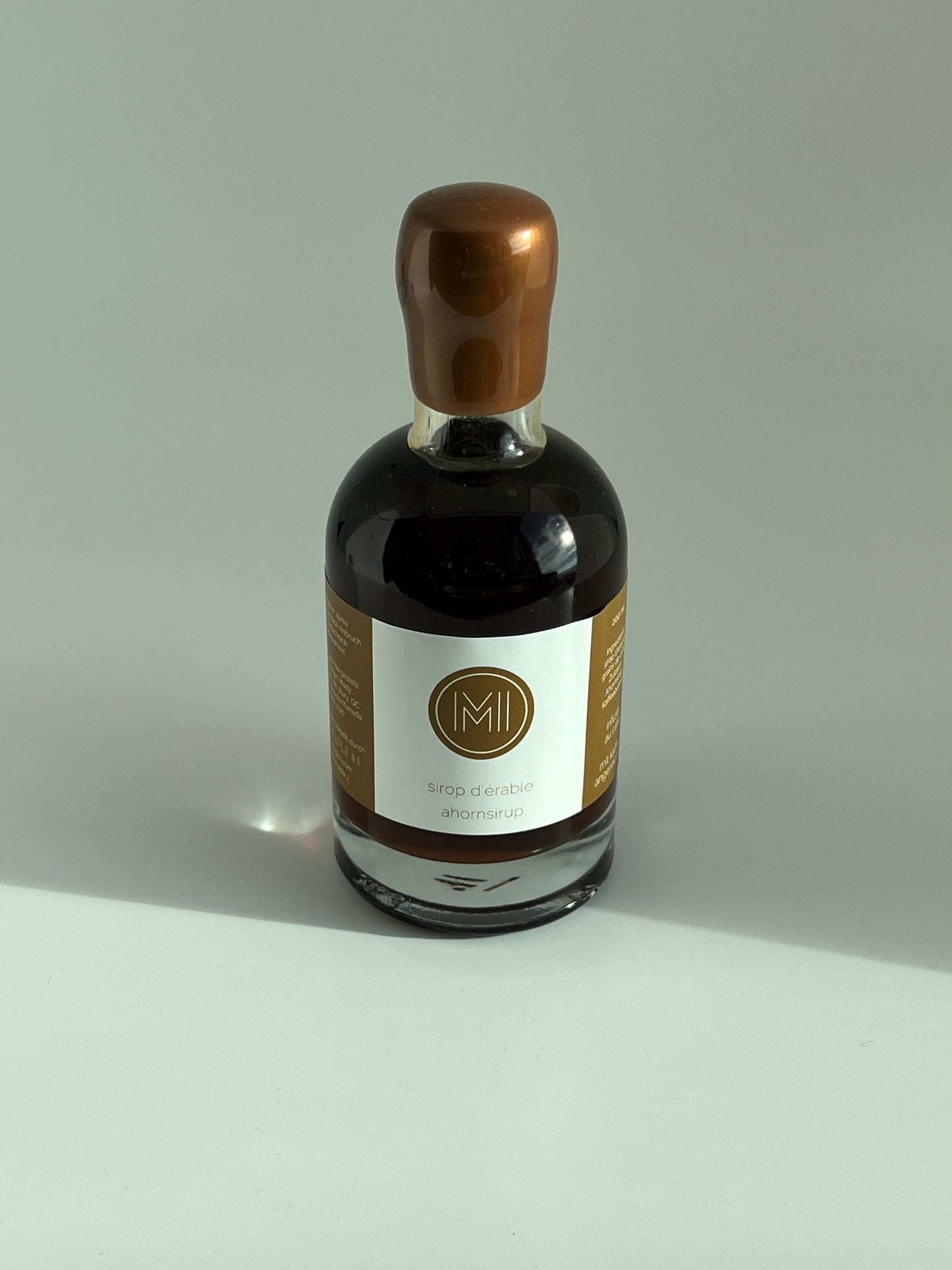 a 200 ml bottle of coffee infused maple syrup with a brown wax