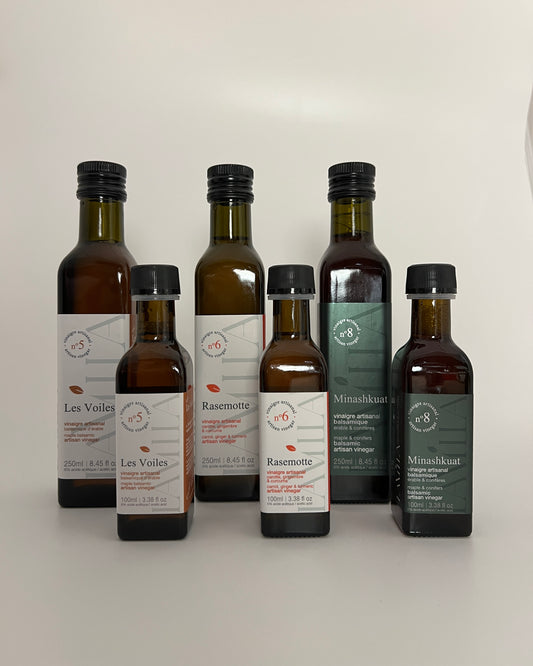 2 rows of side by side bottles of maple vinegars, the first row is with  the smaller bottles size and the second row is with the bigger bottles