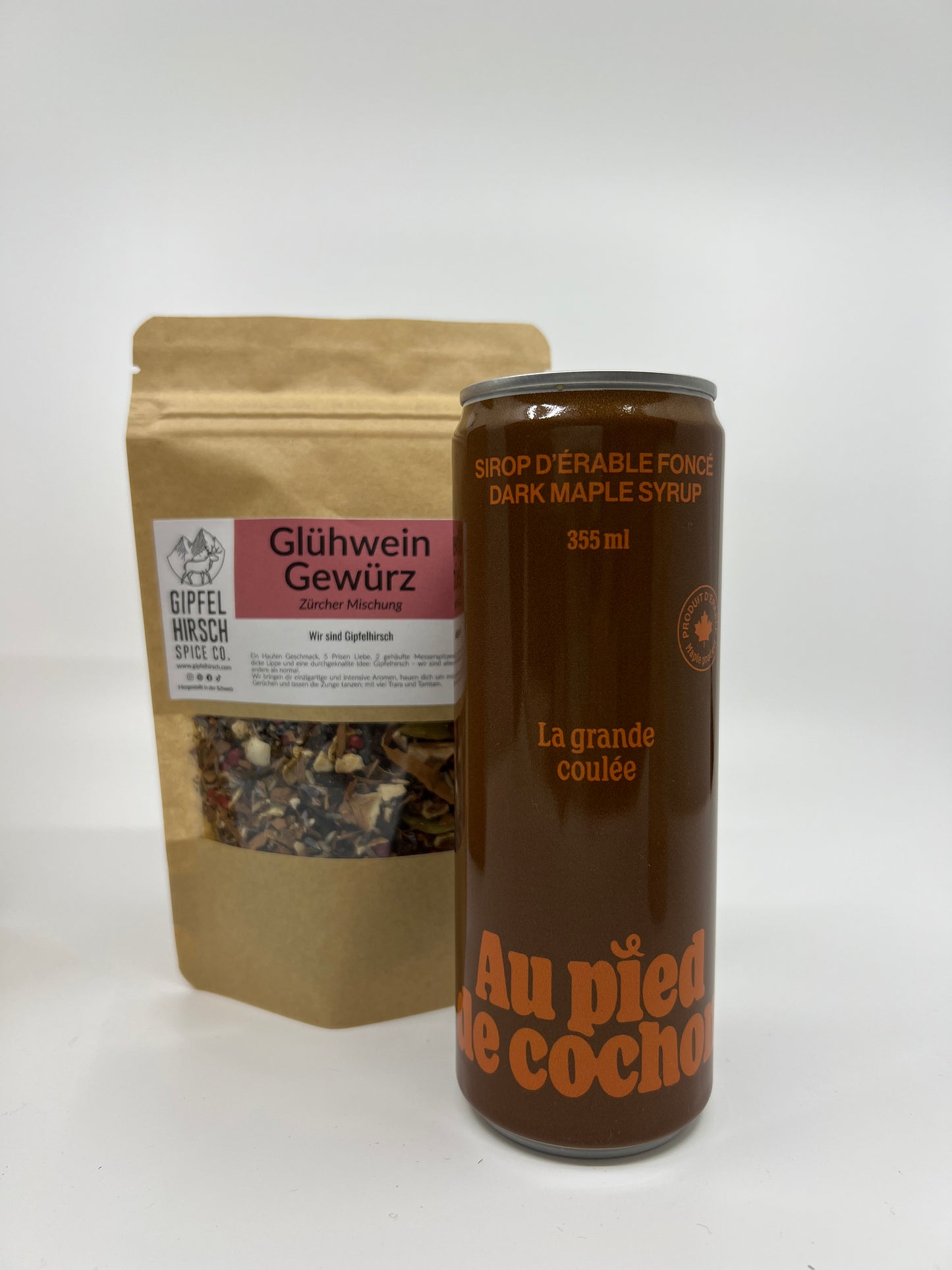 a bottle of 355 ml of dark maple syrup with in second plan a bag of mulled wine spices