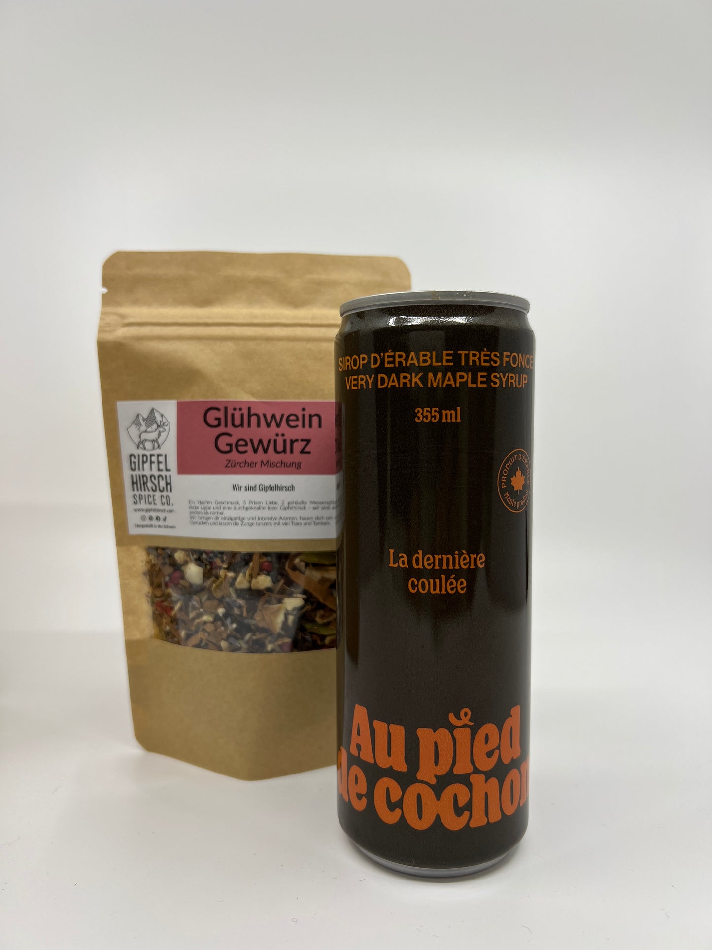 a bottle of 355 ml of very dark maple syrup with in second plan a bag of mulled wine spices