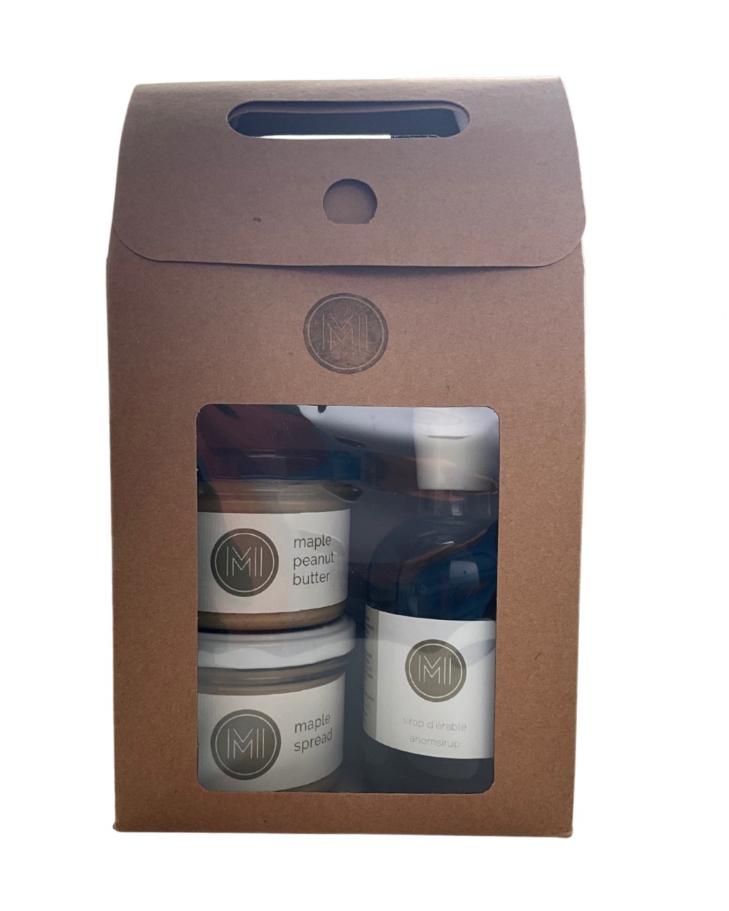 a discovery sets with respectively 2 jars on the left and one bottle of maple syrup presented in a brown carboard bag with ME, MAPLE & I logo and a window showing the products