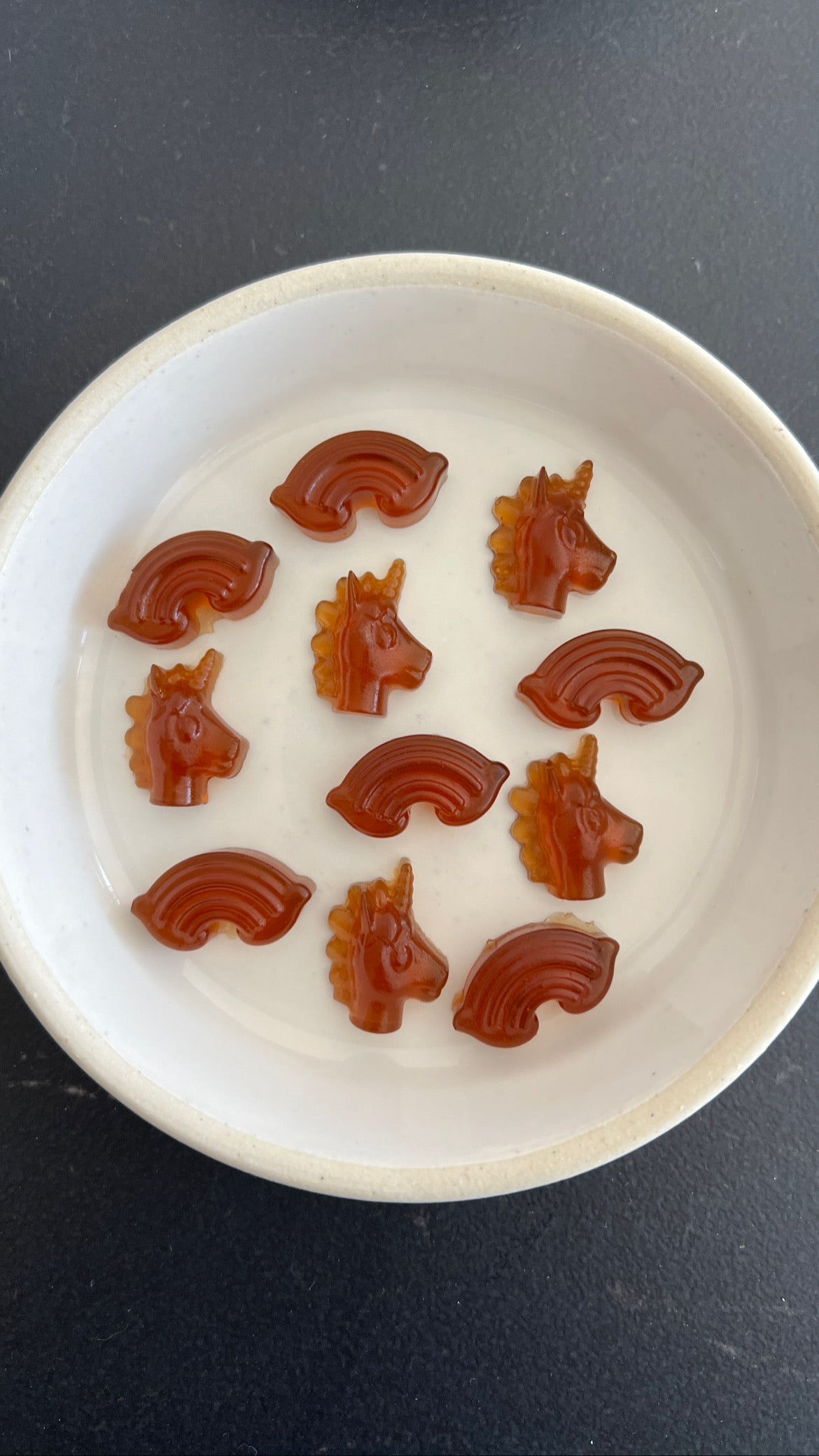 a plate with unicorn and rainbow shaped maple gummies