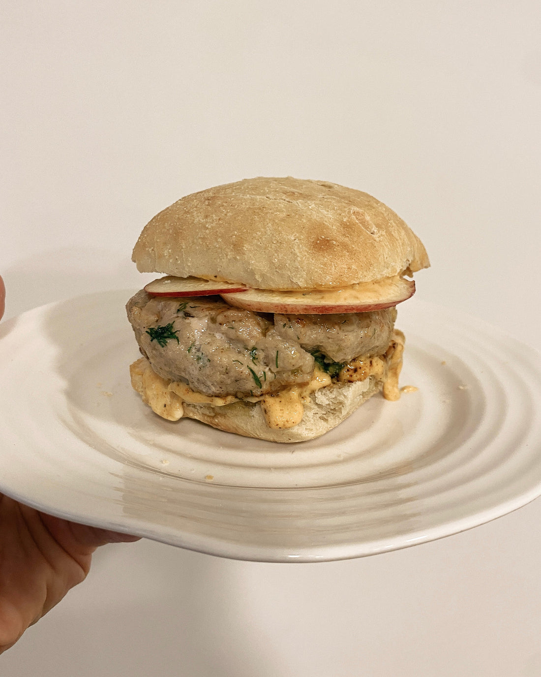 chicken burger with apple garnish and mayo 