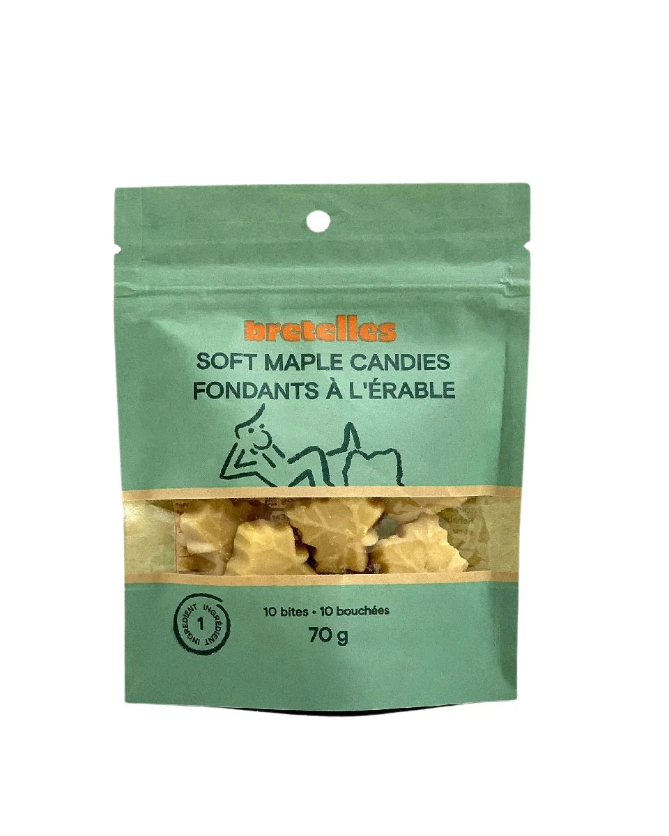 A green stand-up pouch of Bretelles soft maple candies also knows as fondants à l'érable, showing a clear window with the maple leaf-shaped candies inside, on a white background