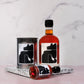Maple syrup bottles and can with black wolf on a marble surface