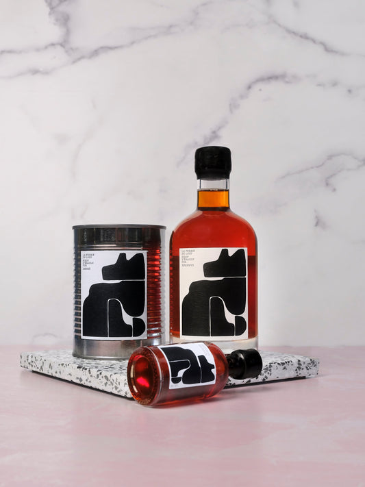 Maple syrup bottles and can with black wolf on a marble surface