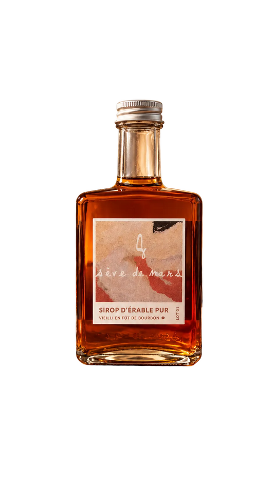 A bottle of pure maple sugar syrup ''vieilli en fût de Bourbon'' from Sève de Mars on a white background