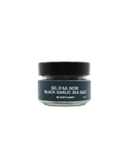 A small glass jar of Saint Laurent Black Garlic Sea Salt from Sel St-Laurent with a black lid and a dark label, centered on a plain white background.