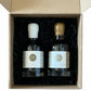 Two bottles of maple syrup in a cardboard box on a wooden surface