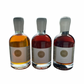 3x200ml side by side bottles of golden, amber and dark maple syrup facing in front with no background