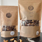 spring - two maple seasonal granola bags with chocolate and cashews side by side on a countertop 