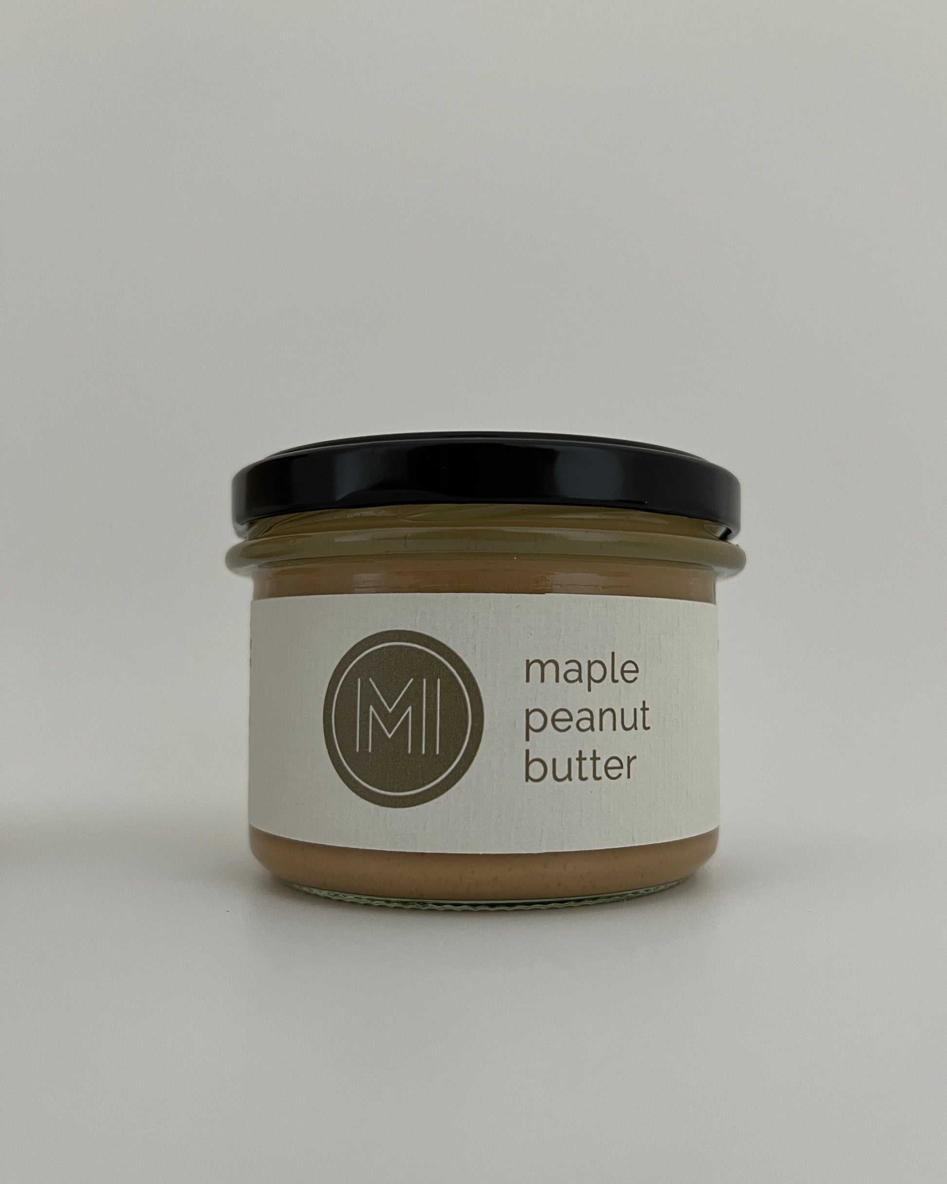 a medium size maple peanut butter jar on a white background