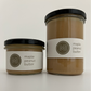 a medium size and a tall size maple peanut butter jars side by side with black lids on a white background