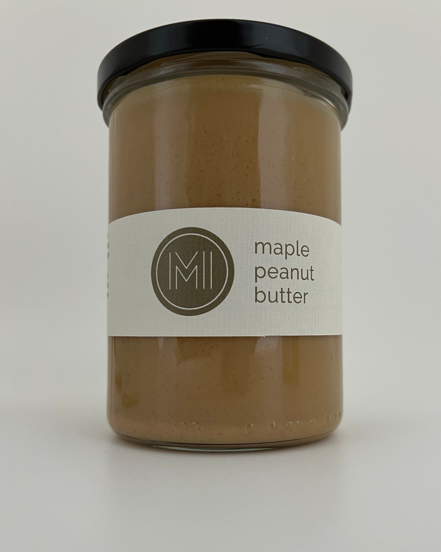 a tall size maple peanut butter jar on a white background