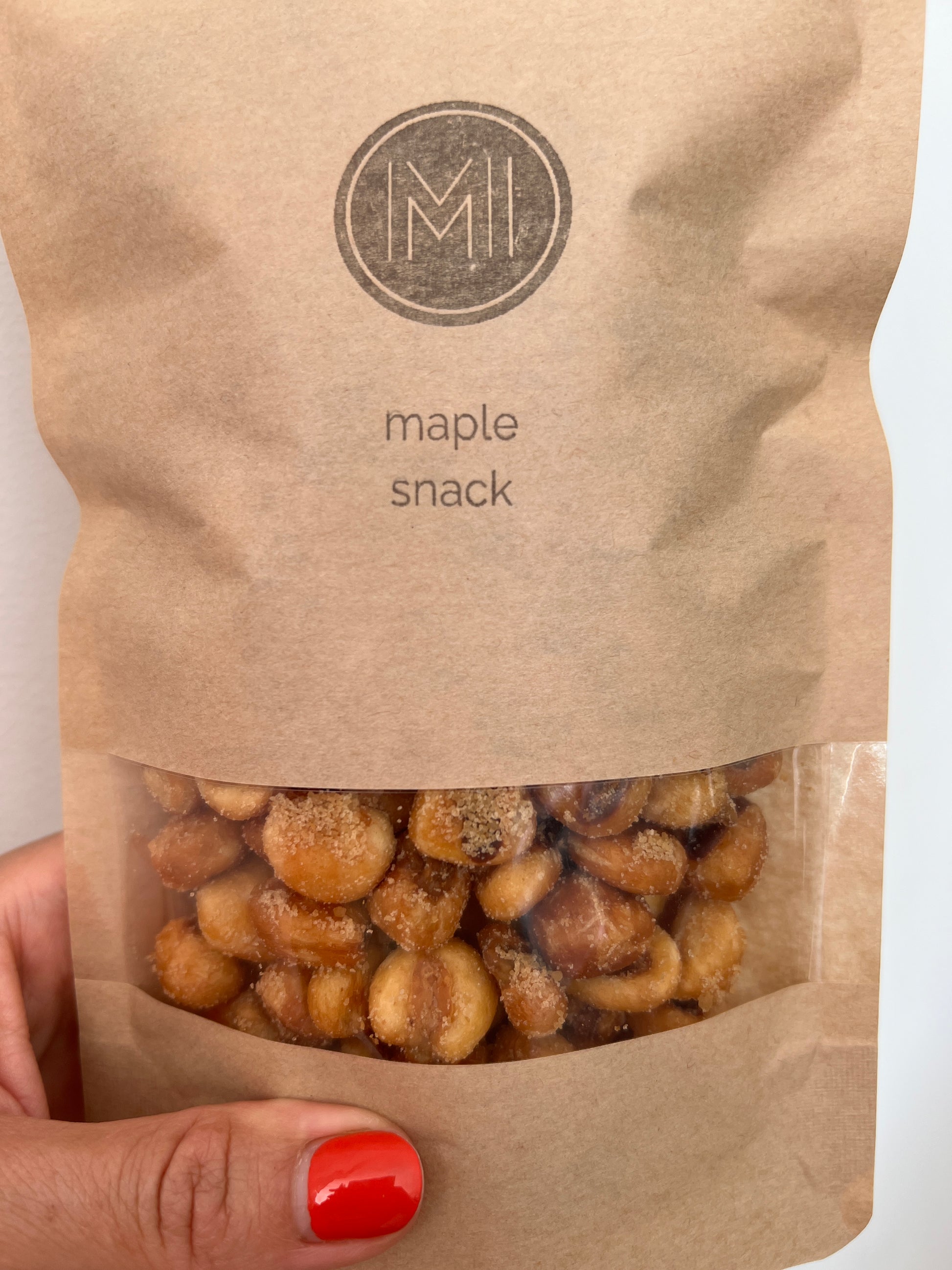 hand holding maple corn kernels bag 