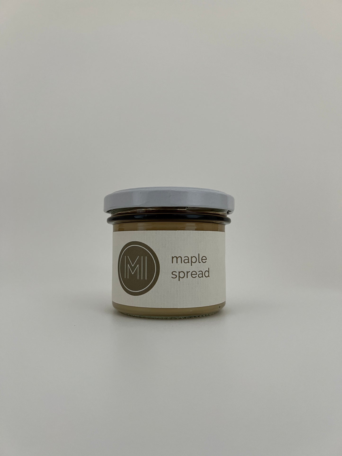 a small size spread jar with white lid on a white background