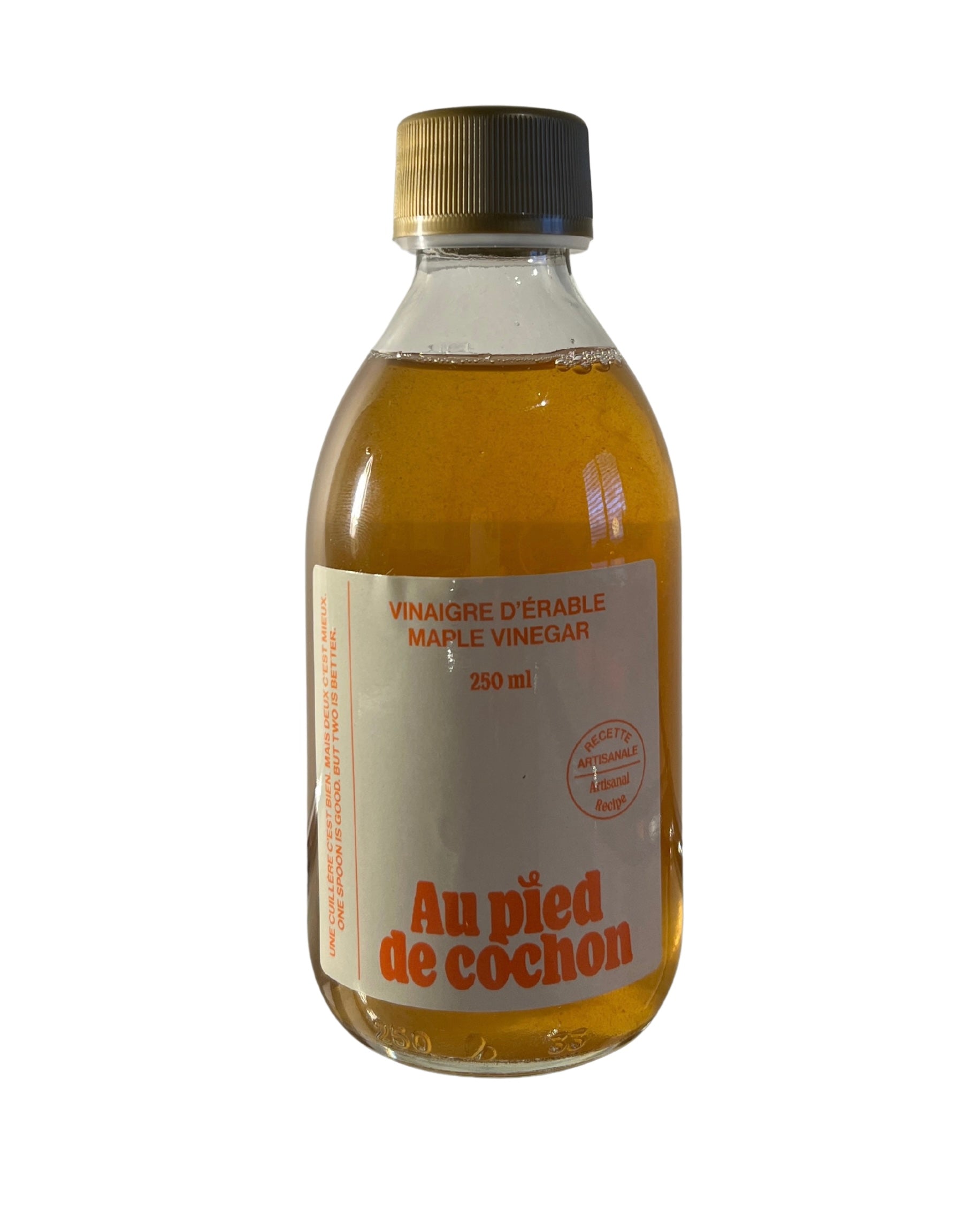 Bottle of maple vinegar with a white label on a white background