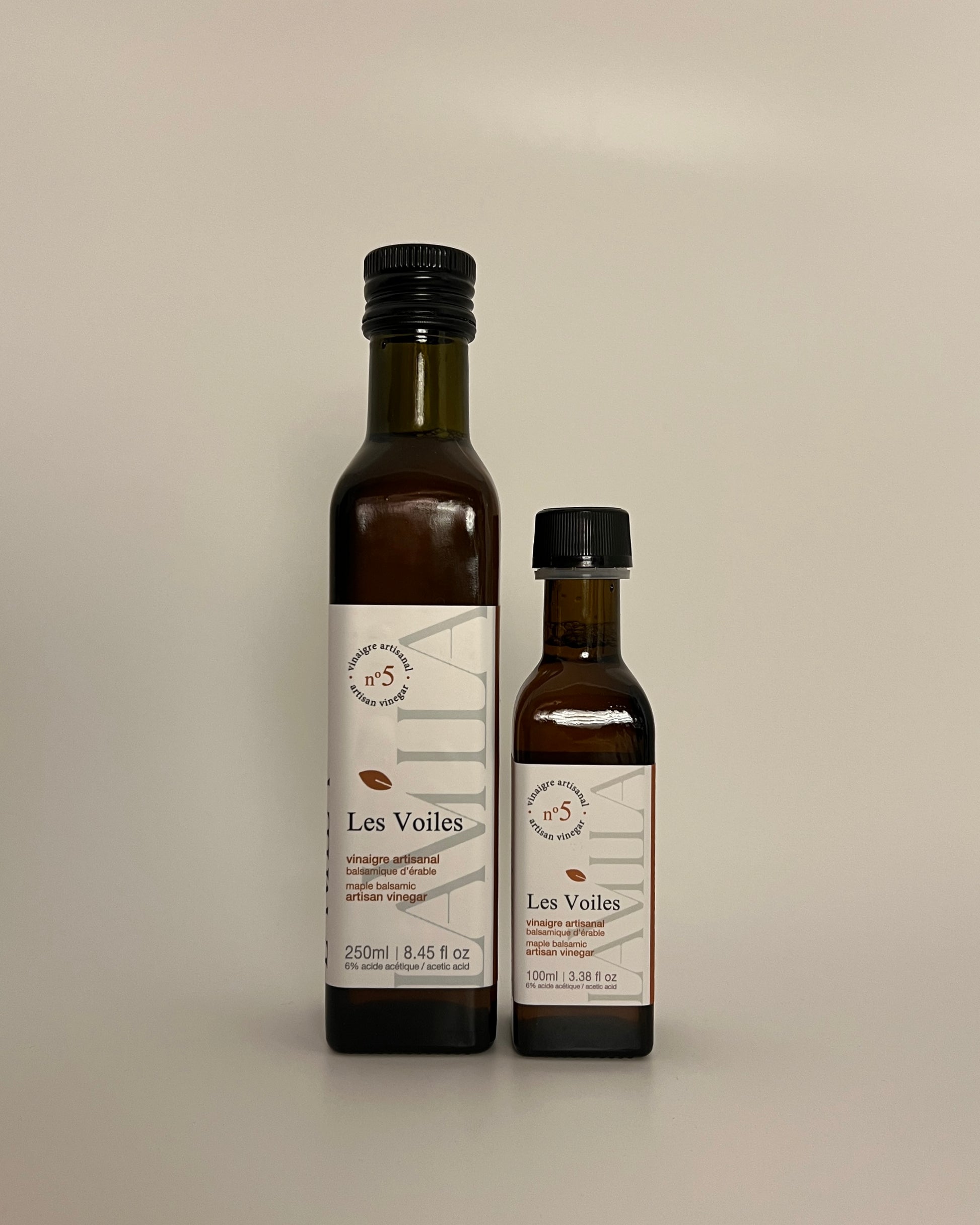 2 side by side bottles of different sizes of maple vinegars no.5 named Les Voiles