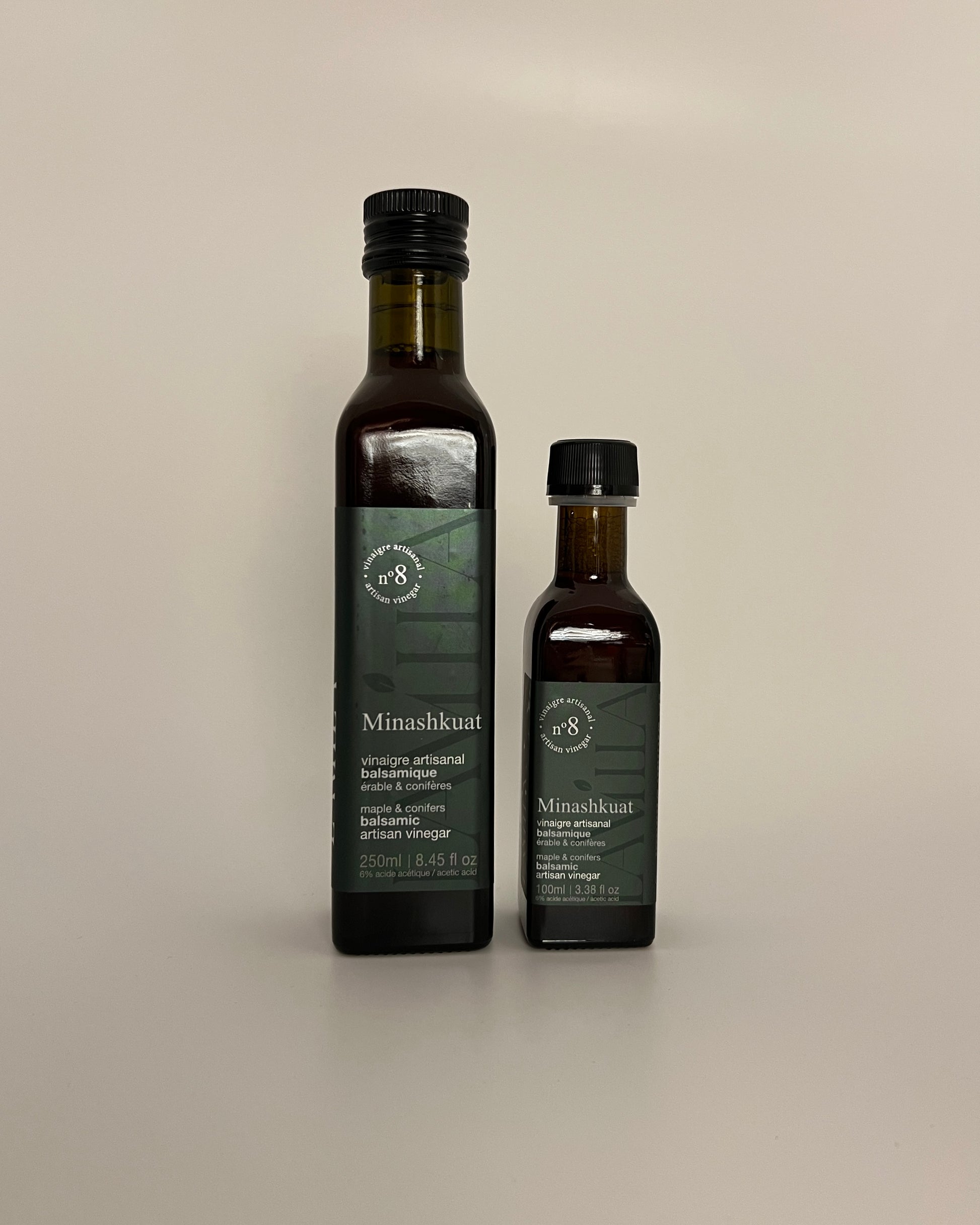 2 side by side bottles of different sizes of maple vinegars no.8 named Minashkuat