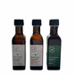 3 side by side bottles of maple vinegars standing with no background