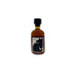 An amber maple syrup in a small glass bottle with a black cap and a white label featuring a bold black graphic, centered on a plain white background.