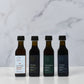 Four bottles of of maple vinegar on a marble surface
