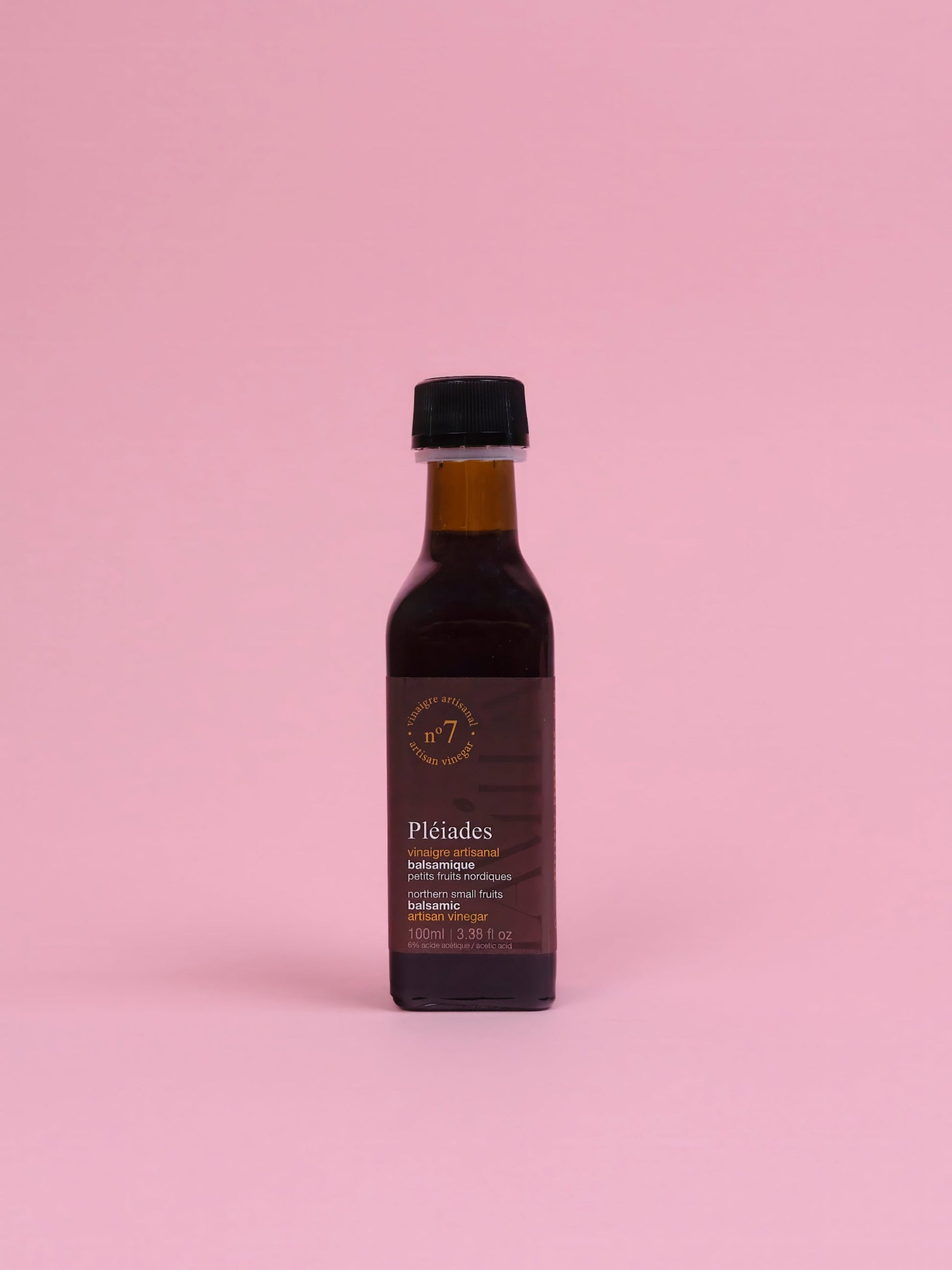 Bottle of Pleiades olive oil on a pink background