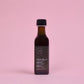 Bottle of Minashkuat on a pink background