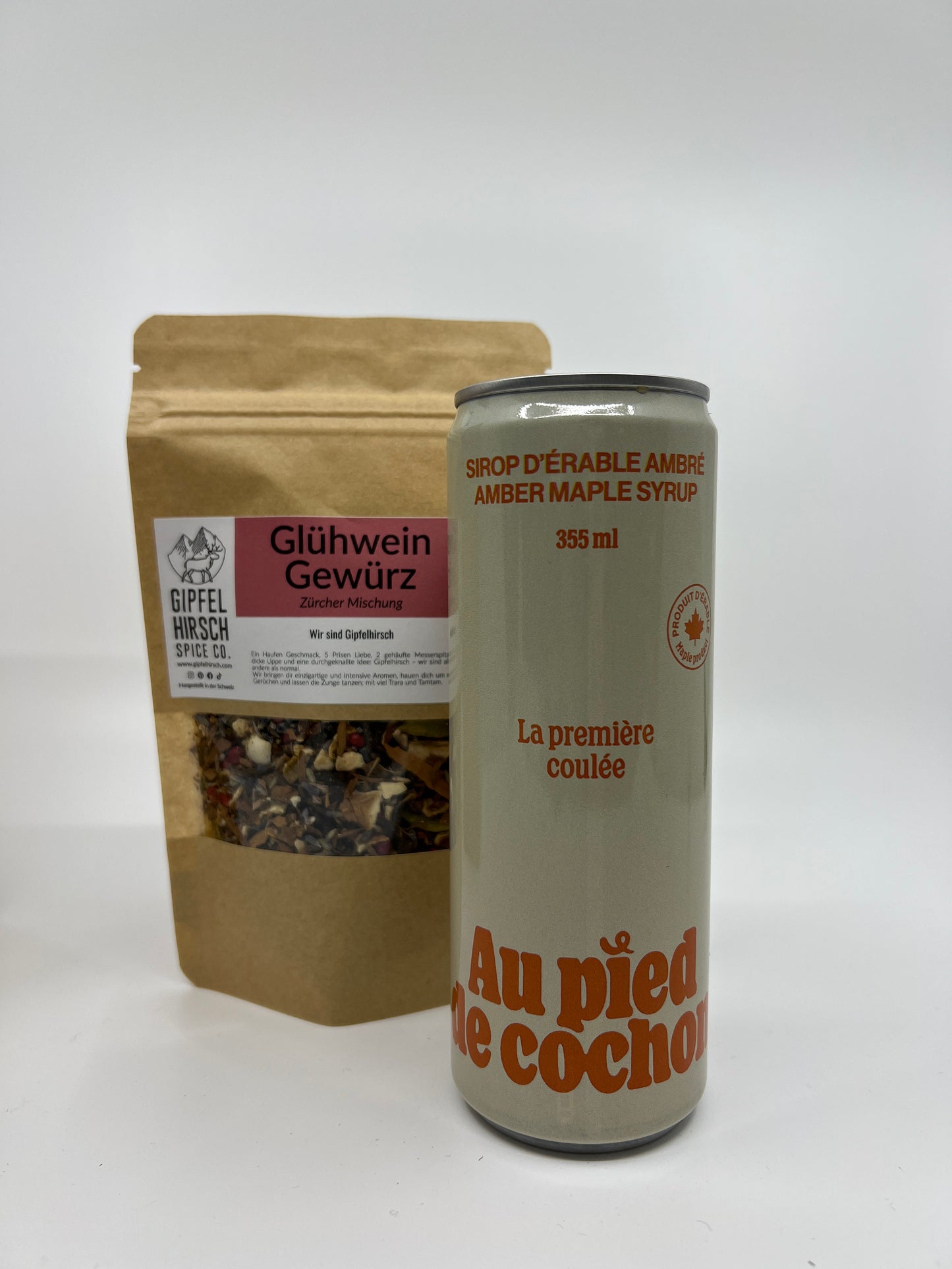 a bottle of 355 ml of amber maple syrup with in second plan a bag of mulled wine spices