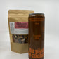 a bottle of 355 ml of dark maple syrup with in second plan a bag of mulled wine spices