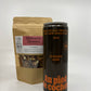 a bottle of 355 ml of very dark maple syrup with in second plan a bag of mulled wine spices