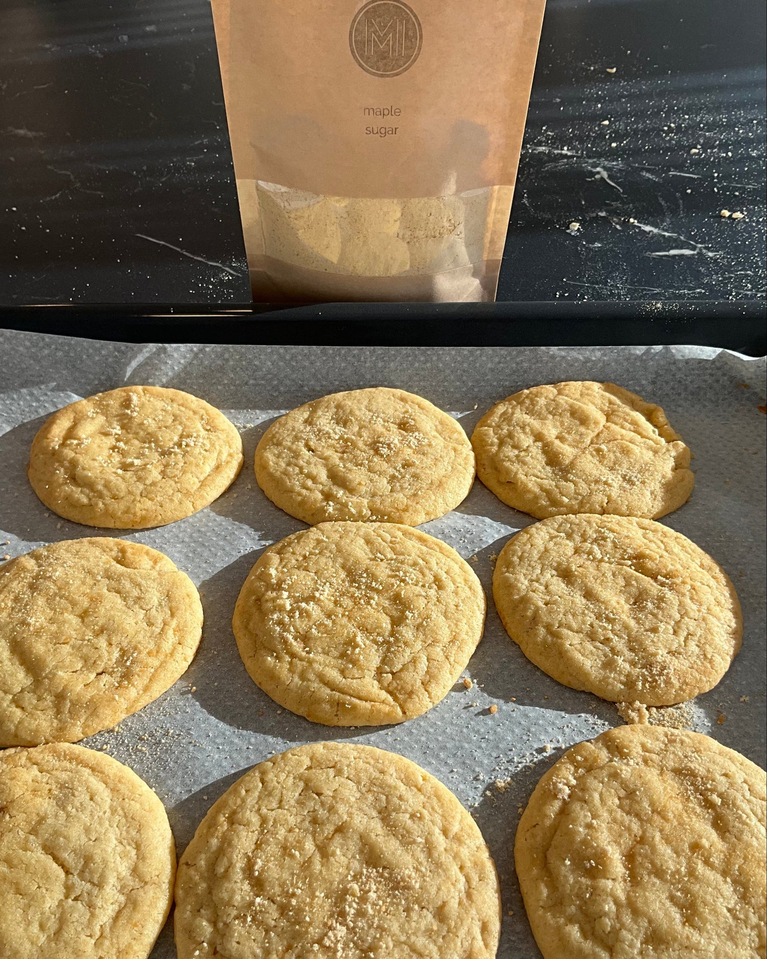 maple sugar cookies on a baking tray and bag of maple sugar from ME, MAPLE & I